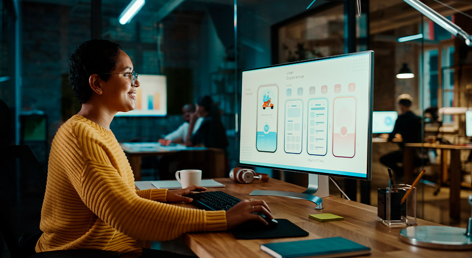 woman working at computer, doing design. Marketing team member. 