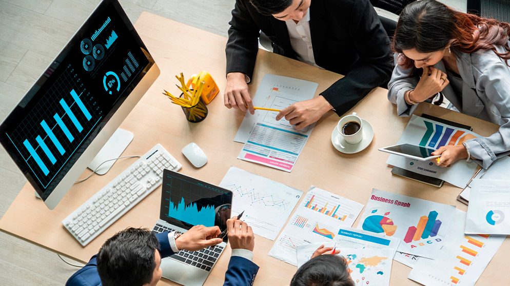 Marketing team working at table with coffee and elements 